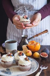 Cropped shot of person’s hands holding a sweet cupcake