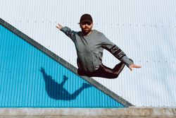 Trendy male flipping on street