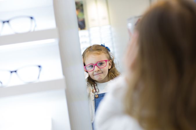 Young girl trying on glasses