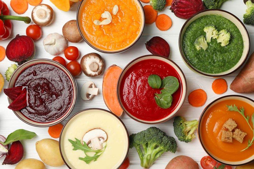 Scattered soups and vegetables with on wooden table