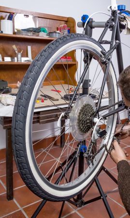 Real bicycle mechanic repairing custom fixie bike