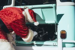 Santa Claus repairing old van