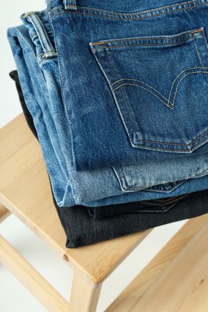 Folded jeans on a wooden chair