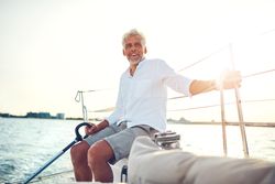 Man sitting and relaxing on sailing yacht on sunny day