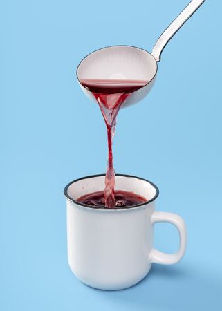 Mulled wine in a rustic enamel mug