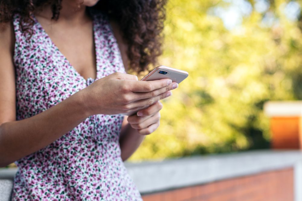 Close-up of an unrecognizable woman using a smartphone
