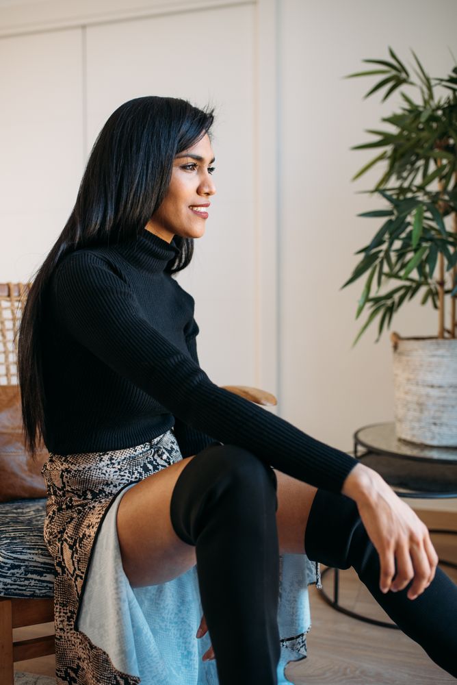 Stylist beautiful young Black woman sitting in a chair