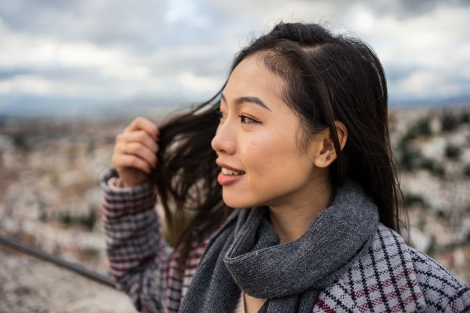 Cheerful woman visiting ancient city