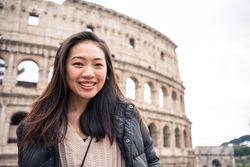 Cheerful Asian traveler outside famous landmark