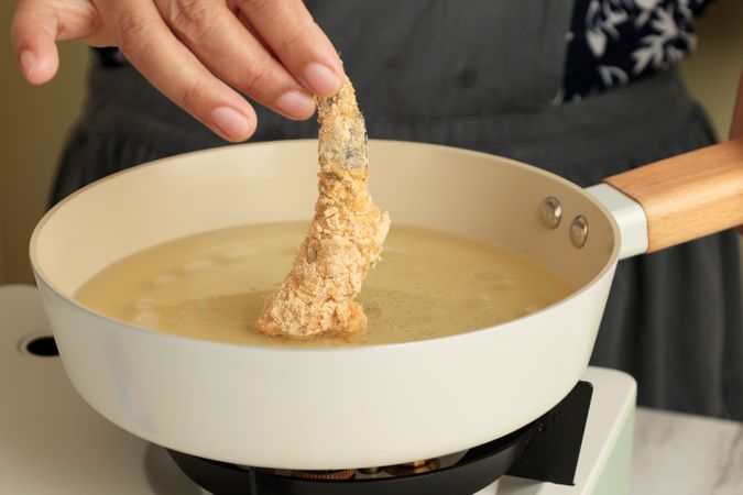 Chef frying prawns in oil