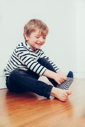 Boy wearing socks on floor