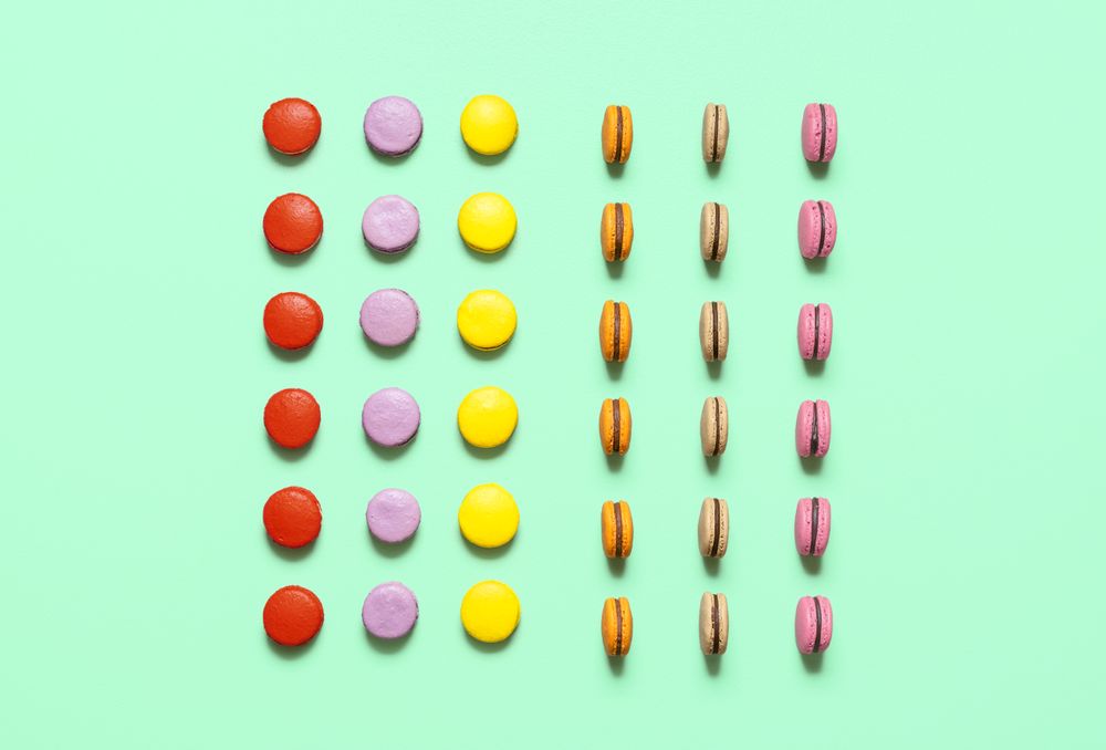 Multicolor macarons cookies with chocolate ganache filling, symmetric aligned