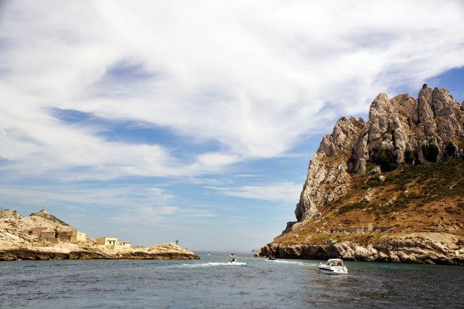 Limestone rocks and boats sailing in sea
