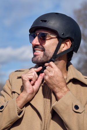 Content man putting on helmet