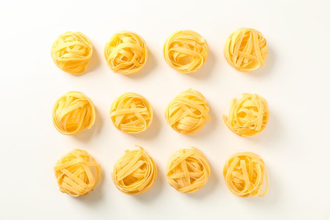 Flat lay composition with different pasta on bright background, space for text