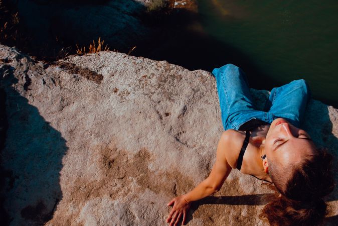 Young woman relaxing on rock