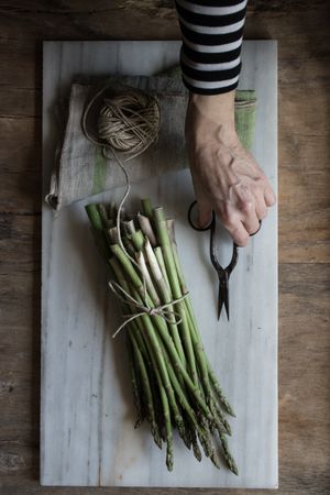 Arrangement of twine and asparagus on board