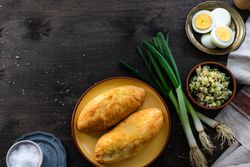Top view of traditional Georgian pies with eggs, rice and green onion with copy space