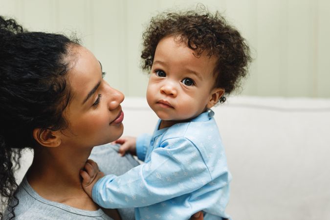 Portrait of a baby boy in mother’s arms