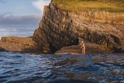 Woman on paddleboard floating in sea