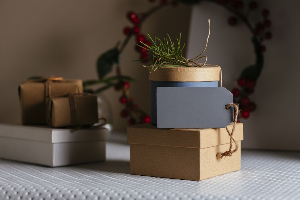 stacked Gifts boxs, wrapped in recycled paper and empty tag on table