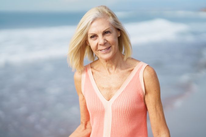 Smiling woman standing on the coast