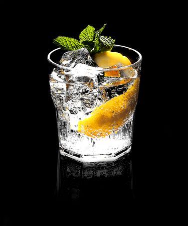 Tasty cocktail in glass with lemon