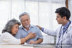 Asian wife embraces mature husband after receiving diagnosis of sickness from doctor 5lQpY4
