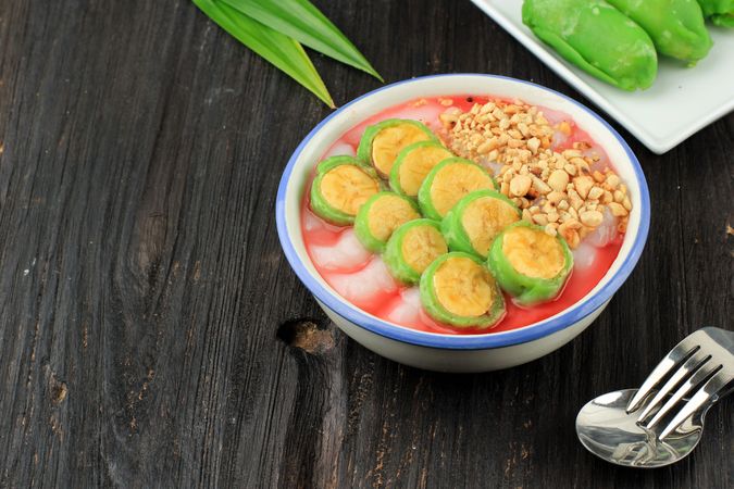 Bowl of es pisang ijo, Indonesian dessert with space for text