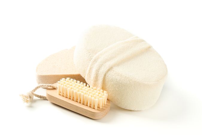 Wooden bath brush and sponges isolated on plain background