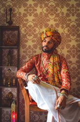 Man wearing turban sitting on chair looking away