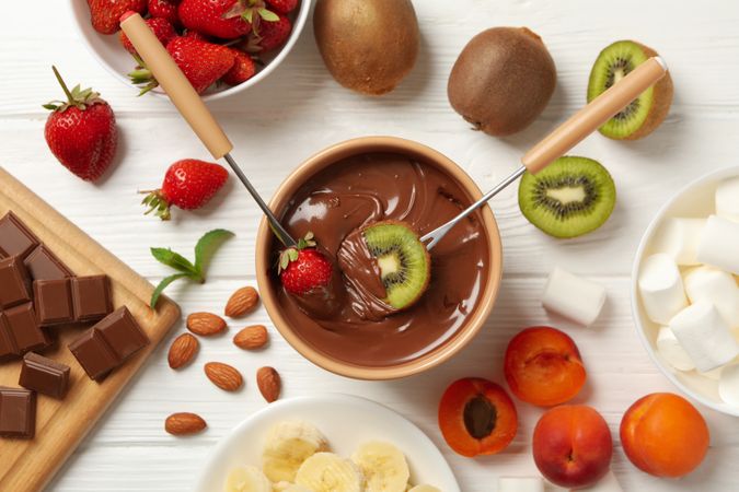 Composition with ingredients for chocolate fondue on wooden background. Cooking fondue