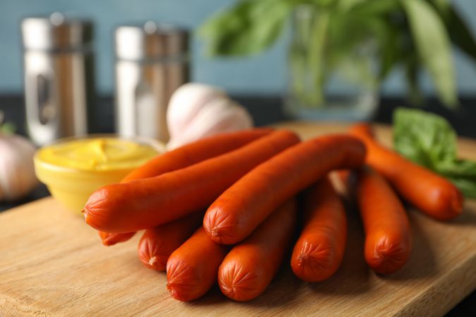 Hot dogs on bread board in kitchen