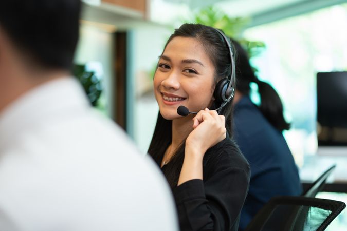Smiling female operator working in call center