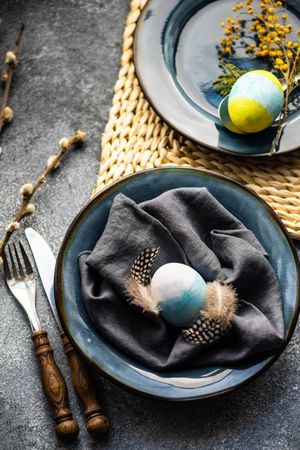 Top view of table setting with pastel egg decor and pussy willow