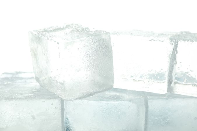 Close up of clear square ice cubes in bright room