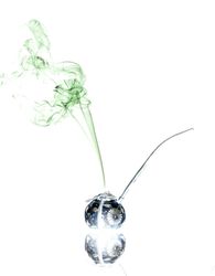 Jar with herbs emitting smoke