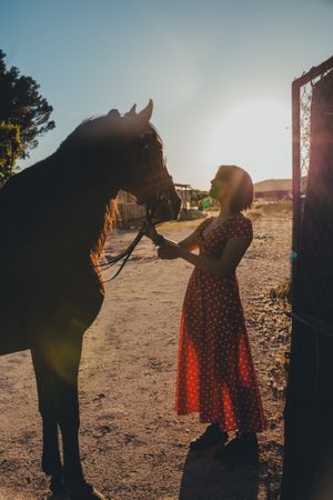 Young woman with horse on ranch
