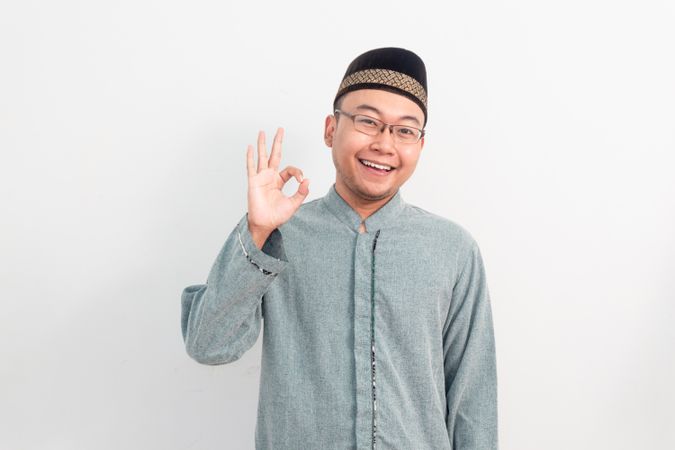 Asian Muslim man doing ok hand sign in Ramadan