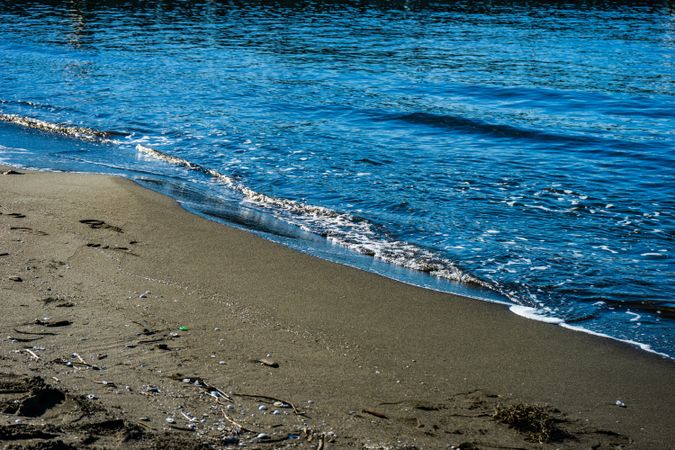 Dark volcanic sand beach and sea