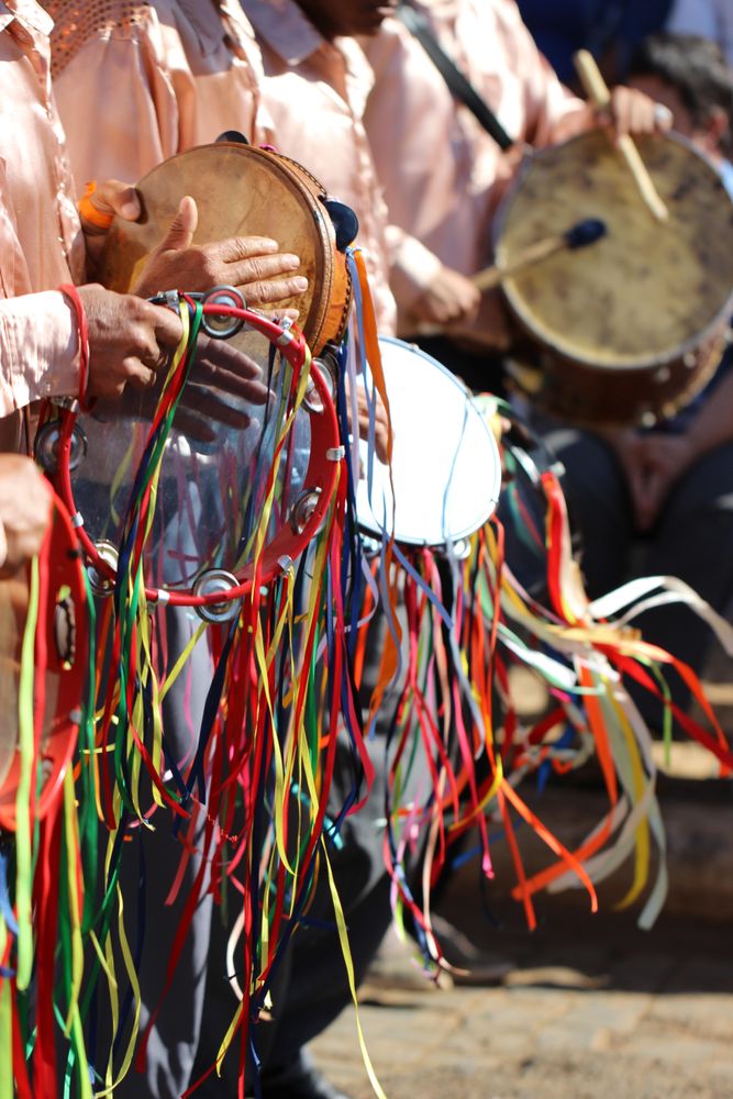 Group of men in light shirts playing drum