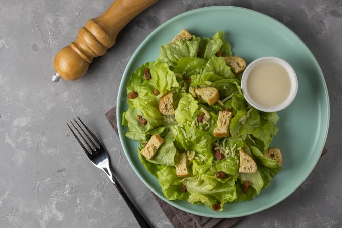 Caesar salad with croutons and bacon.