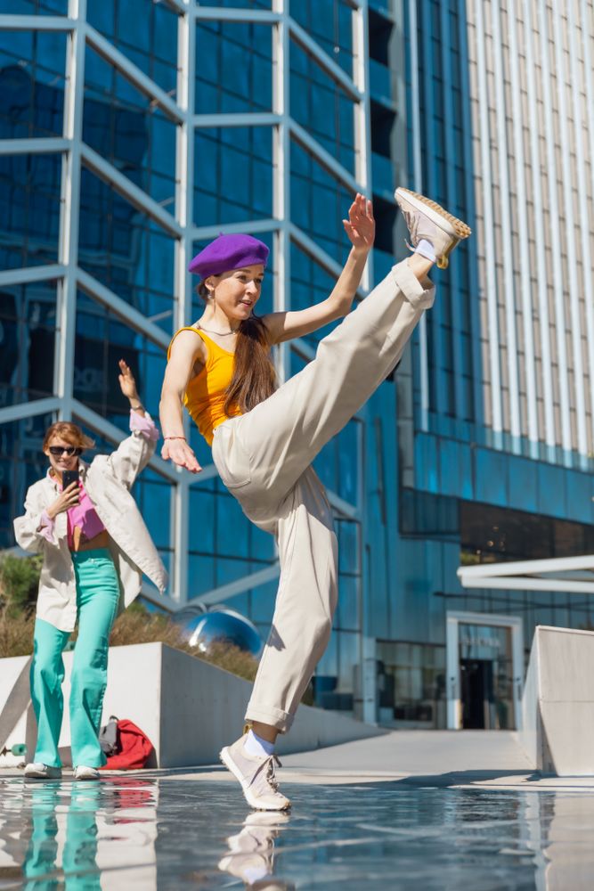 Vertical Screen: Young And Stylish Female Hip Hop Dancer Freestyling On City Street In the Circle Of Fashionable Friends.