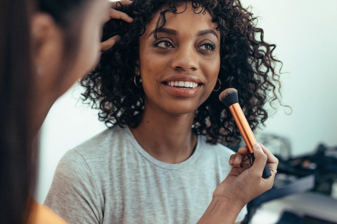 Makeup artist preparing a model for a photo shoot