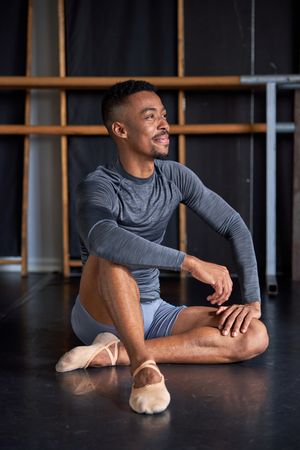 Photo portrait of a Black dancer with sport clothes and slippers and ballet in a dance academy