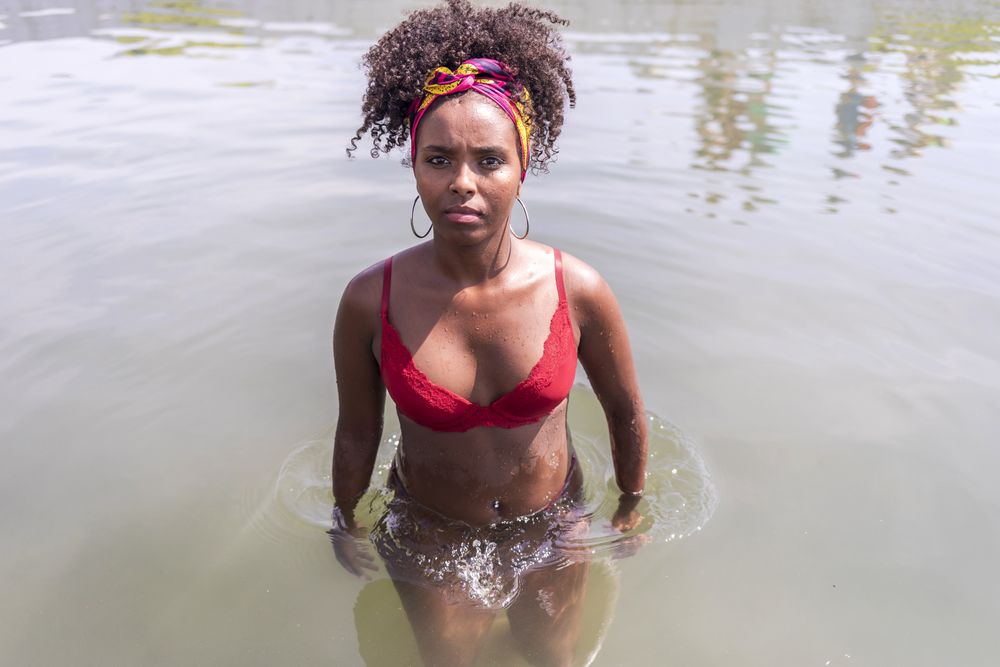 Young woman on vacation in the water looking at camera