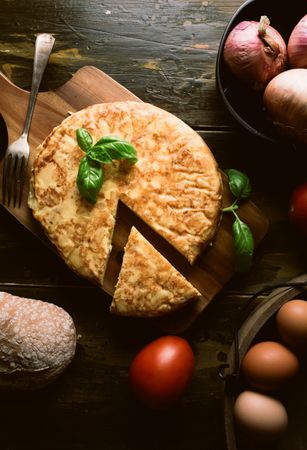 Cooking ingredients around pie on table