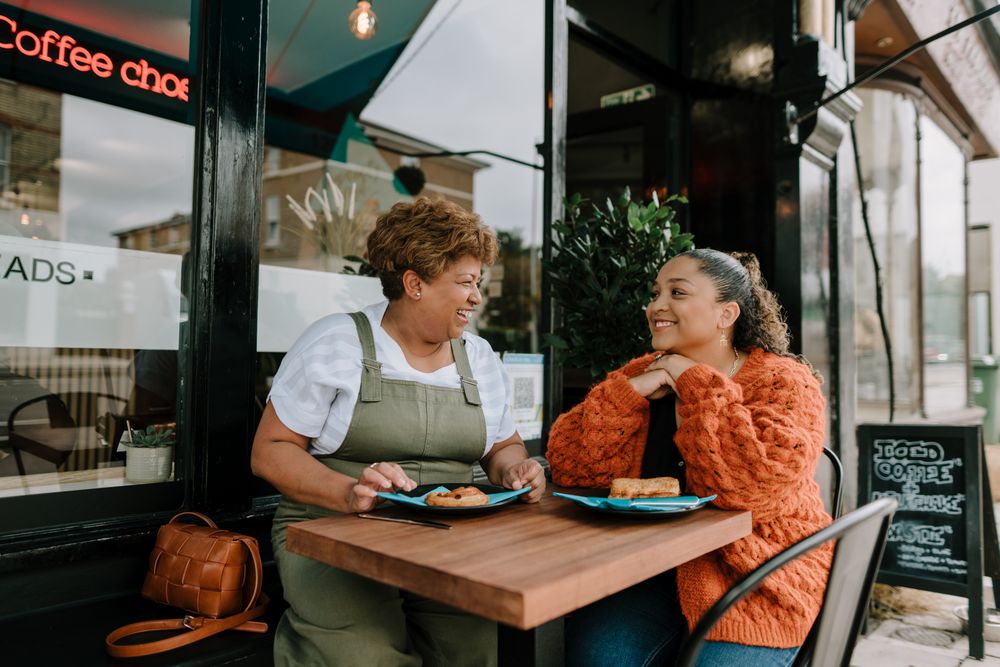 Mother and daughter enjoying lunch at outdoor table