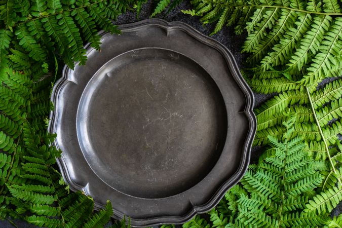 Summer table setting with fern surrounding dark plate