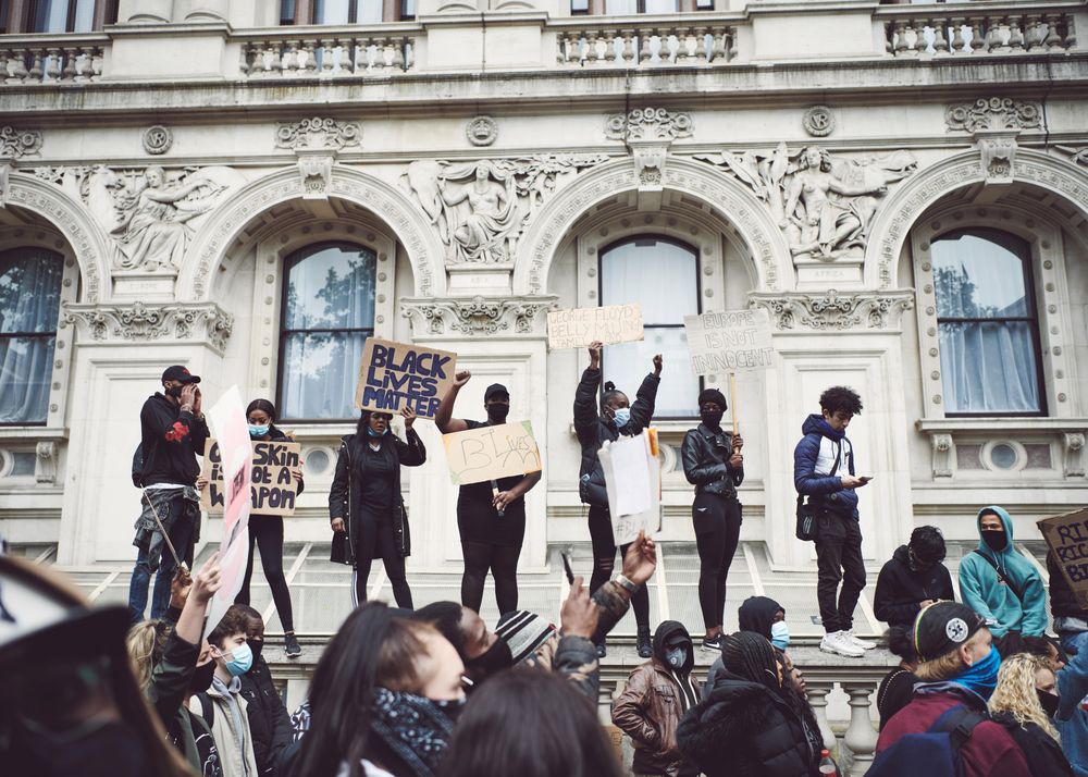 London, England, United Kingdom - June 6th, 2020: Group of BLM protesters standing on a fence